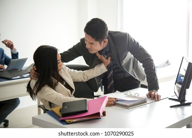 Businessman sexually harassing businesswoman colleague in office.