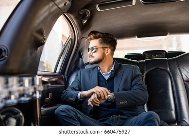 Businessman With Shades In Limousine, Looking Trough The Window