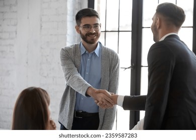 Businessman shake hand greeting get acquainted with smiling male employer at meeting, business partners handshake closing deal at briefing, make agreement at office negotiation, acquaintance concept - Shutterstock ID 2359587283