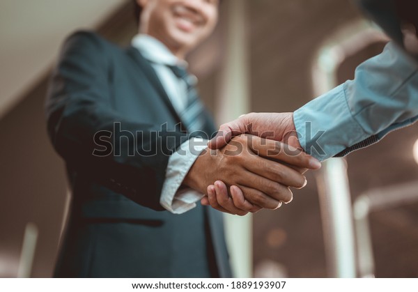 Businessman shake hands and get to know each other\
before they start talking about business.Bussiness,working, success\
concept 