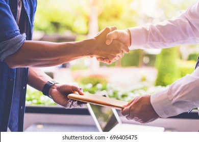 Businessman Shaking Hand After Receive Document From Delivery Man