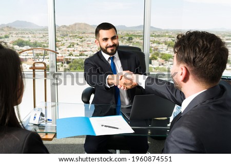 Businessman shaking hands with a company executive after making a lucrative business deal. Smiling sales representative making a successful sale 