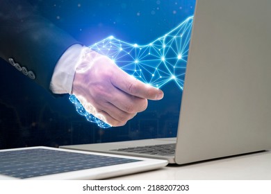 Businessman shaking hands with digital partner extending from laptop computer on futuristic background. Artificial Intelligence and Machine Learning Processes for the 4th Industrial Revolution