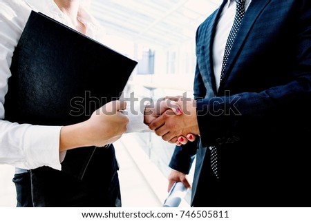 Businessman shaking hands with a girl
