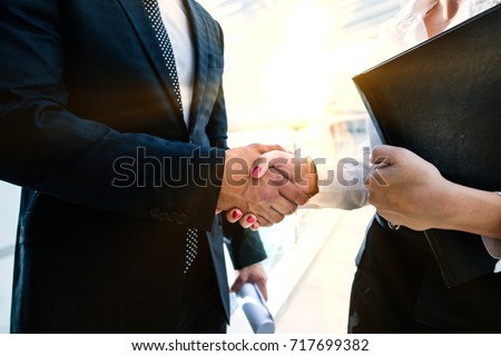 businessman shaking hands with a girl business partner