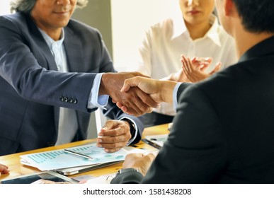 businessman shaking hands to seal a deal with his partner - Shutterstock ID 1581438208