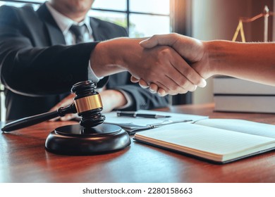 Businessman shaking hands to seal a deal Judges male lawyers Consultation legal services Consulting in regard to the various contracts to plan the case in court. - Shutterstock ID 2280158663