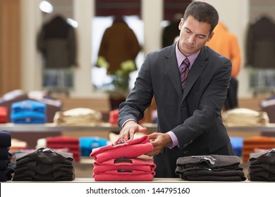 Businessman shopping in clothes store - Powered by Shutterstock