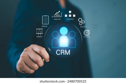 Businessman show CRM Customer Relationship Management for business sales marketing system concept presented in futuristic graphic interface of service application to support CRM database analysis.