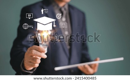 Businessman show light bulb graduation hat. Study E-learning graduate certificate program concept. Internet education course degree, online teacher training knowledge creative thinking idea solution