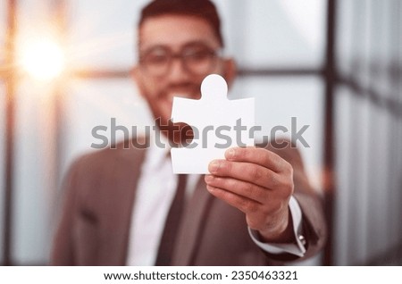 businessman show white jigsaw in hand, business strategy concept