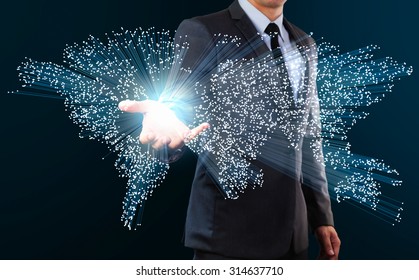 businessman showing blue fiber optics cable forming to world map