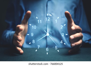 Businessman showing clock. Concept of saving time. - Shutterstock ID 766004125