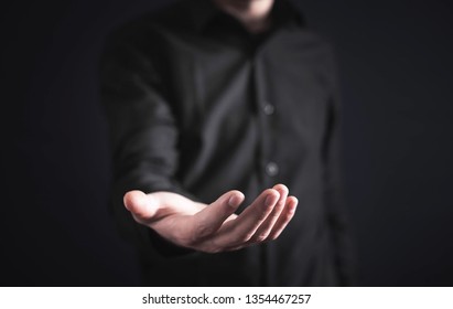 Businessman showing empty hand. - Shutterstock ID 1354467257