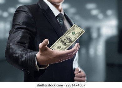 Businessman showing falling dollar in hand on blurred background. - Shutterstock ID 2281474507