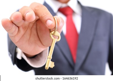 Businessman Showing The Golden Key To Success