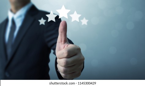 Businessman showing hand sign thumb up and five star symbol to increase rating of company, The excellence of the business or service concept
