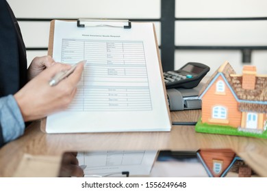 Businessman Showing Home Insurance Quote Request Form