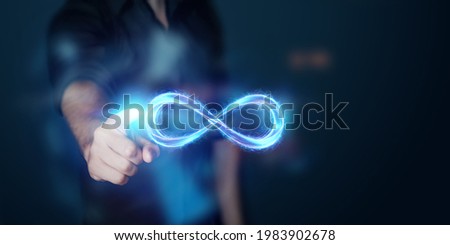 Businessman showing infinity sign, Fire ice sign on gray background.