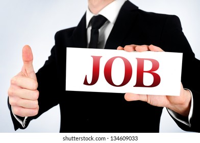 Businessman showing job word on card - Shutterstock ID 134609033