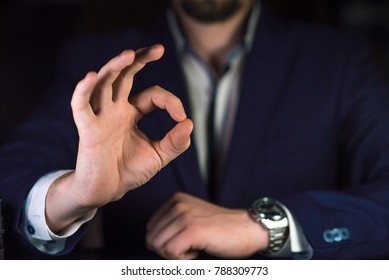 Businessman showing OK by his hand.  Reliable business or service concept