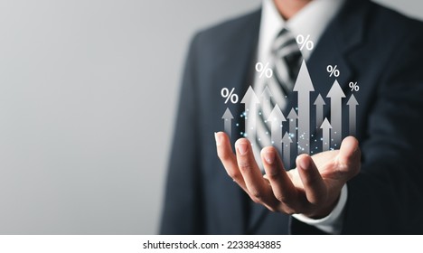Businessman showing percentage icons and up arrow icons with graph indicators. Concept of financial interest rates and mortgage rates.  Interest Rates Stocks Finance Ratings Mortgage Rates. - Shutterstock ID 2233843885