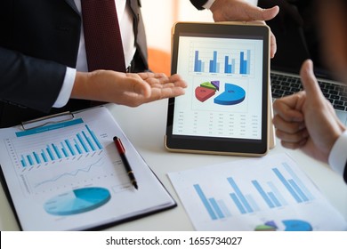 Businessman Is Showing Or Report About Company Profit And Sale Volume Chart To Supervisor Or CEO In The Meeting With Smart Device, Business And Financial Concept  