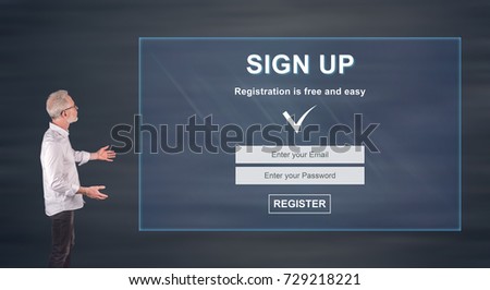 Businessman showing a signup concept on a wall screen