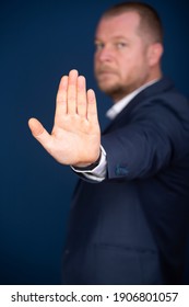 Businessman showing stop sign with hand.