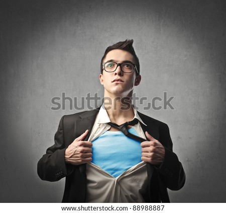Businessman showing a superhero suit underneath his suit