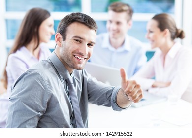 Businessman showing thumbs up