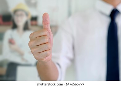 Businessman showing thumbs up - closeup shot.