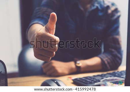 Businessman showing thumbs up - closeup shot