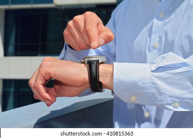 Businessman showing time on his watch. Its time, if not now when concept