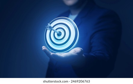 Businessman showing virtual target board on hand. Success concept, planning and setting goals objectives for business investment - Powered by Shutterstock