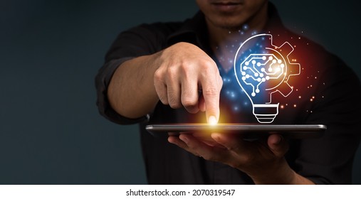 A Businessman Shows A Concept By Holding Half Of A Virtual Lightbulb And His Brain On A Digital Tablet. Insightful Concept And Inspiration For Creativity.