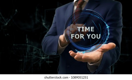 Businessman Shows Concept Hologram Time For You On His Hand. Man In Business Suit With Future Technology Screen And Modern Cosmic Background