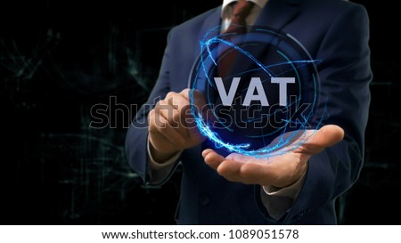 Businessman shows concept hologram VAT on his hand. Man in business suit with future technology screen and modern cosmic background
