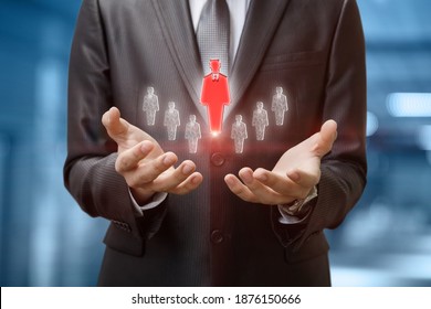 businessman shows selected employee on blurred background