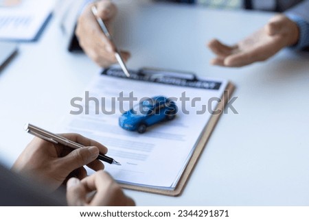 Businessman signing car purchase, lease contract agreement with car salesman, car insurance.