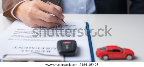 Businessman signing contract document.\
Rental contract, insurance, and contract agreement\
concepts