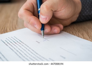 Businessman signing successful conclusion of the business contract