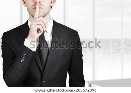 businessman silent quiet gesture with finger