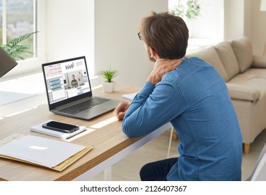 Businessman sit at desk work online on laptop at home suffer from backache from incorrect posture. Unwell male employee have remote job on computer have neck pain. Sedentary lifestyle.