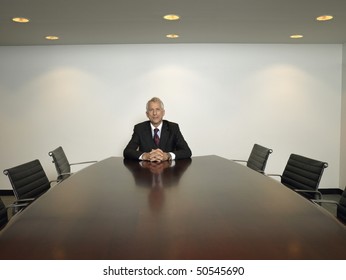 Businessman Sitting Alone In Conference Room