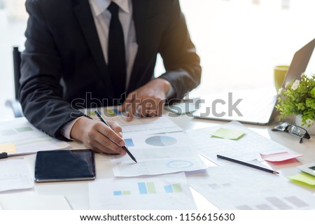 Businessman sitting analyze document information in the workplace.