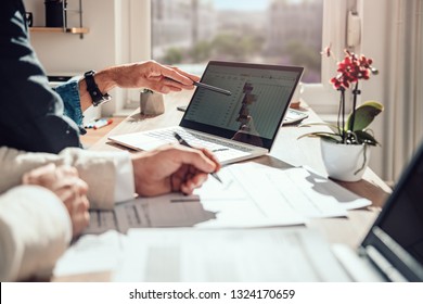 Businessman Sitting By The Desk And Analyzing Project Timeline