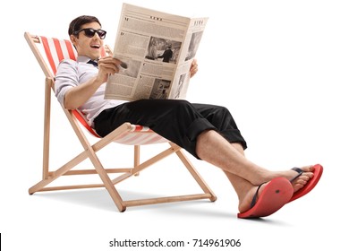 Businessman sitting in a deck chair and reading a newspaper isolated on white background - Powered by Shutterstock