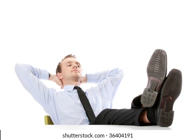 Businessman sitting at desk, isolated