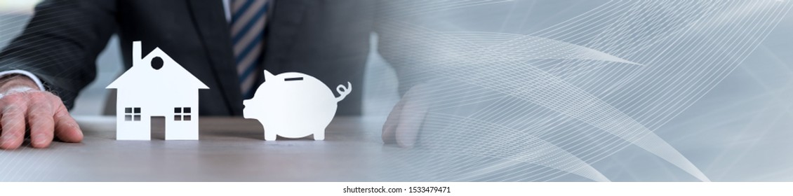 Businessman Sitting In Front Of A Paper Piggy Bank And A Paper House; Panoramic Banner